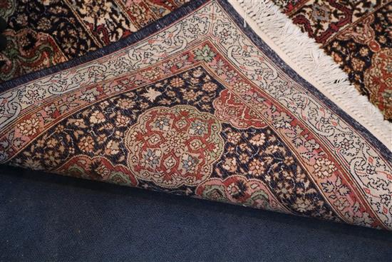 A Kashmir blue ground silk on cotton carpet, 13ft 8in by 8ft 10in.